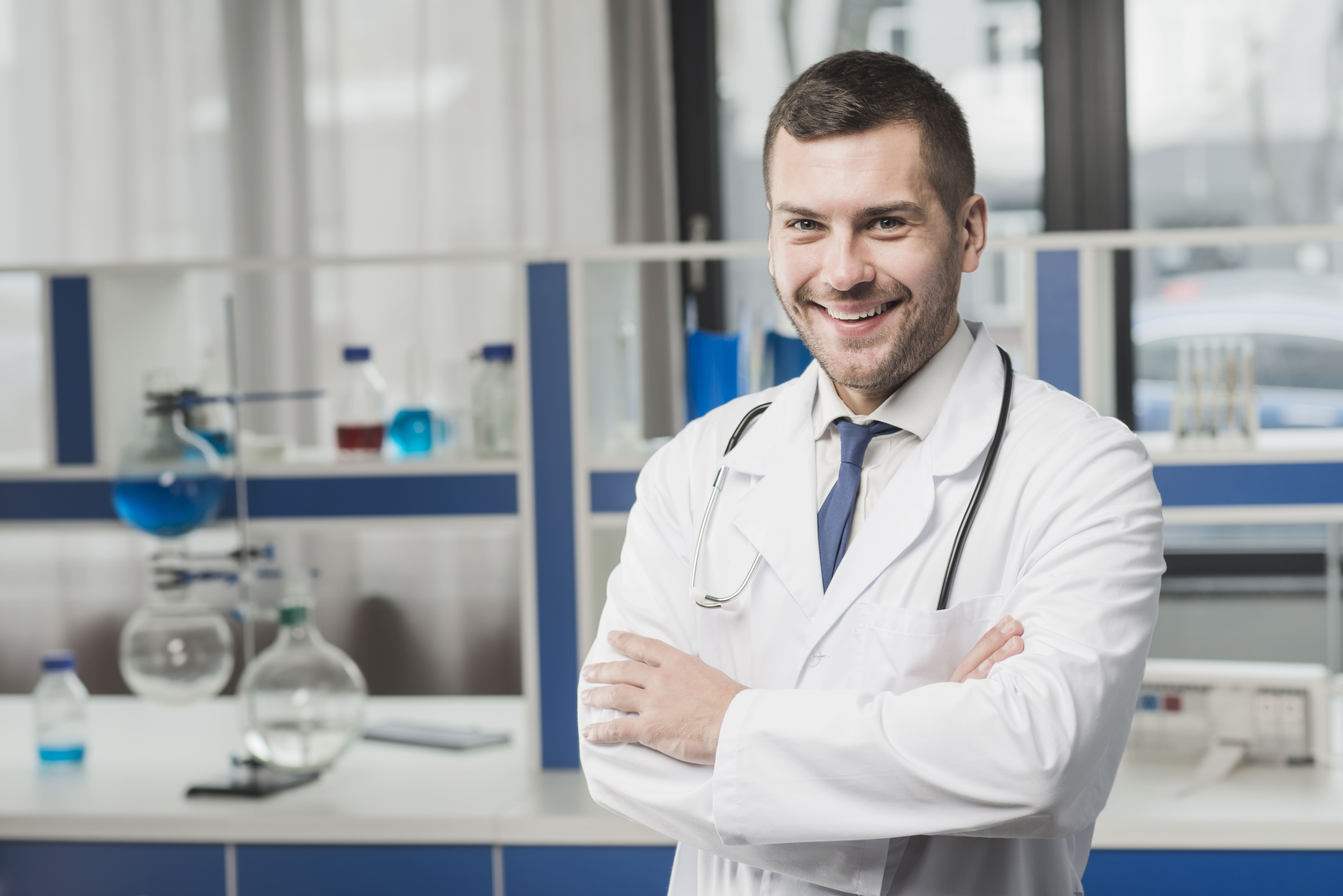 CareRCM Medical Coding Specialists - Male doctor smiling in lab coat for accurate medical coding and revenue optimization